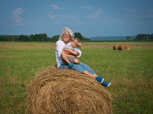 Myrna Bryce on hay bale with myrna